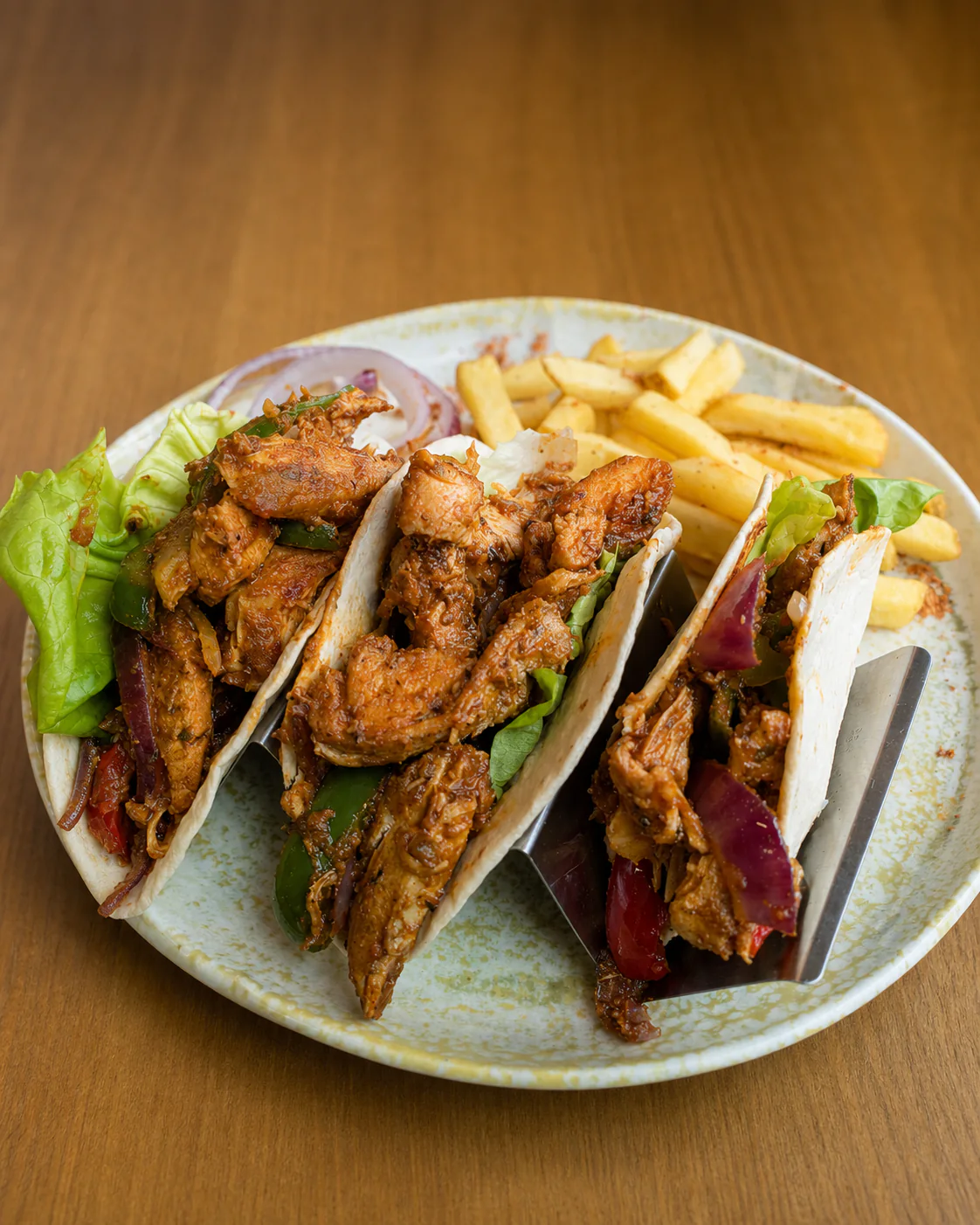 Fabrica's spiced chicken tacos served with chips